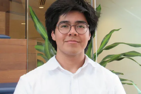 A photo of student Luiz Matat Lopez. He has dark hair and wears a white shirt.
