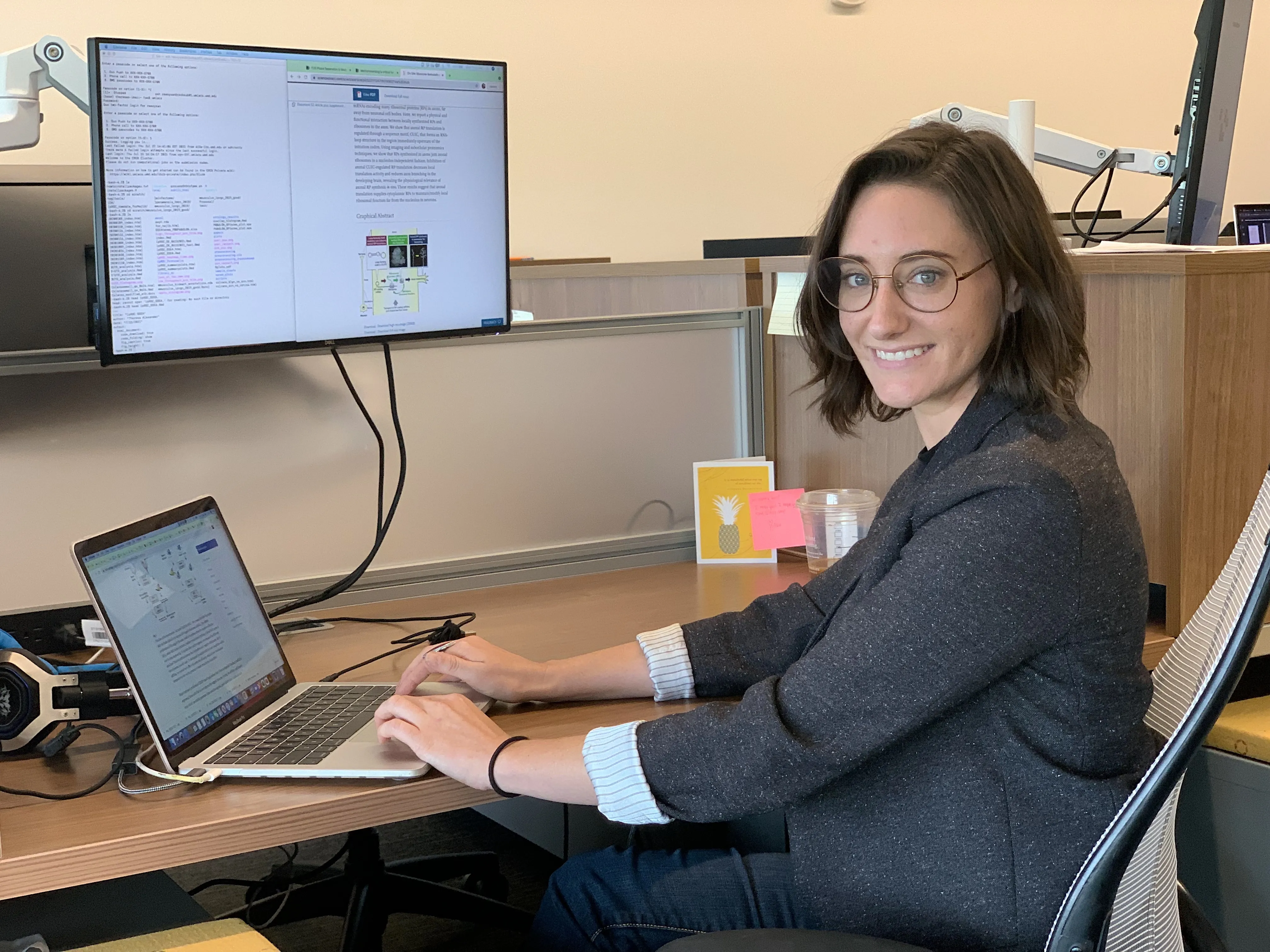 woman smiling at two computers
