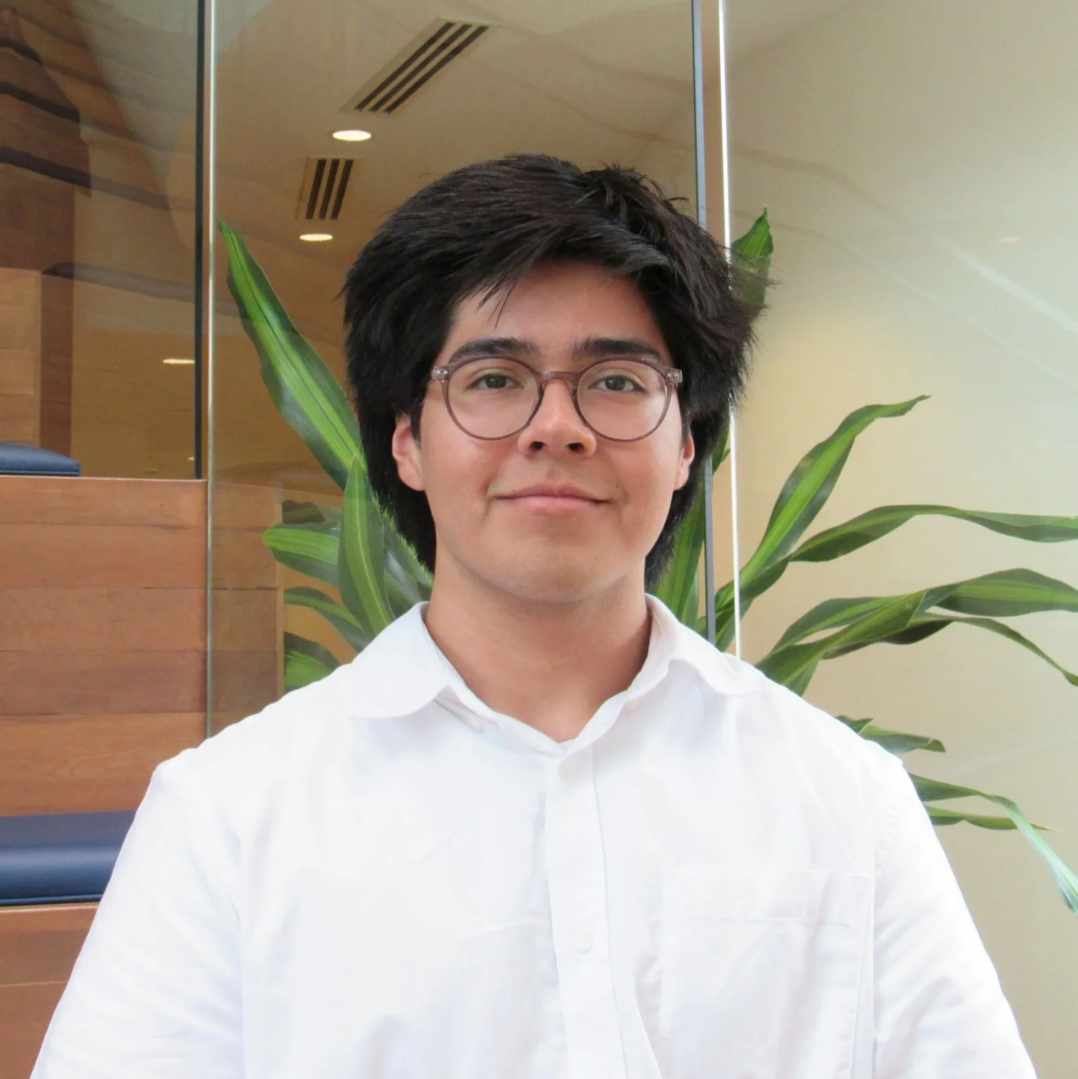 A photo of student Luiz Matat Lopez. He has dark hair and wears a white shirt.